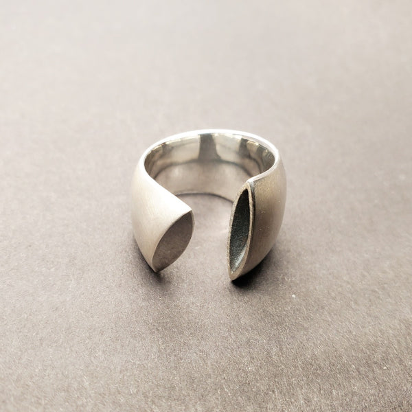 Large rounded and polished open band with one oxidized and one polished sterling silver end approx.18mm wide, size 6.5