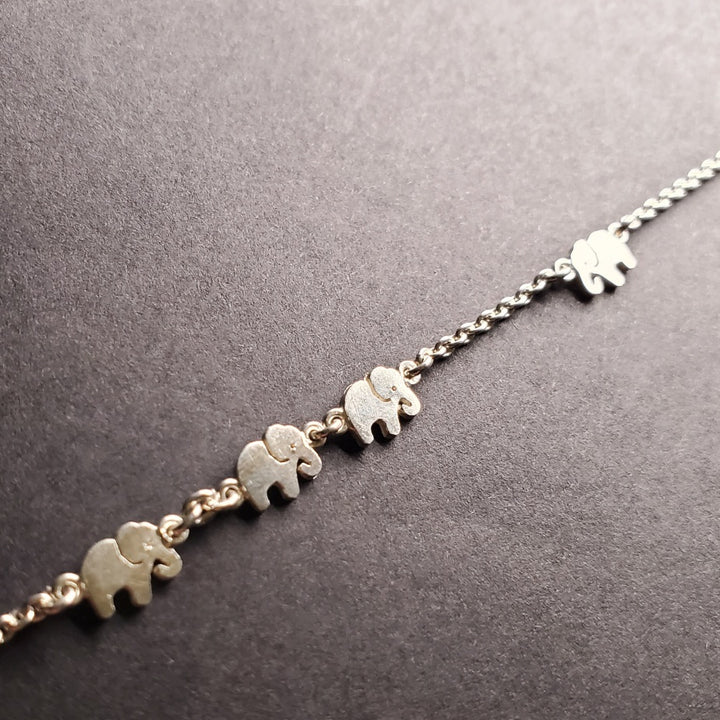 Sterling silver anklet with elephant pattern.