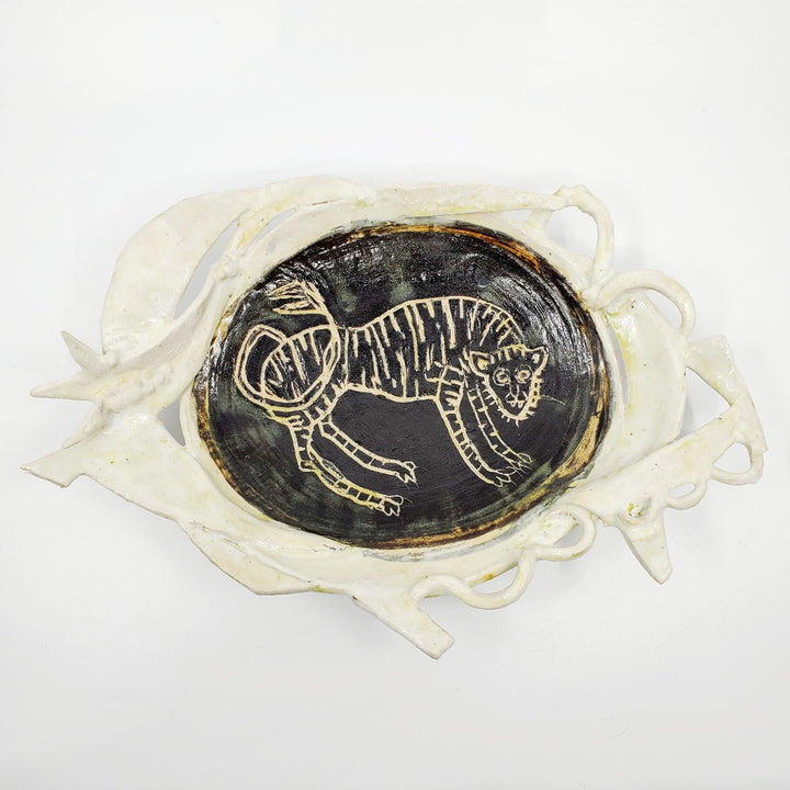 Medium-large oval platter with a tiger carved into the glaze.