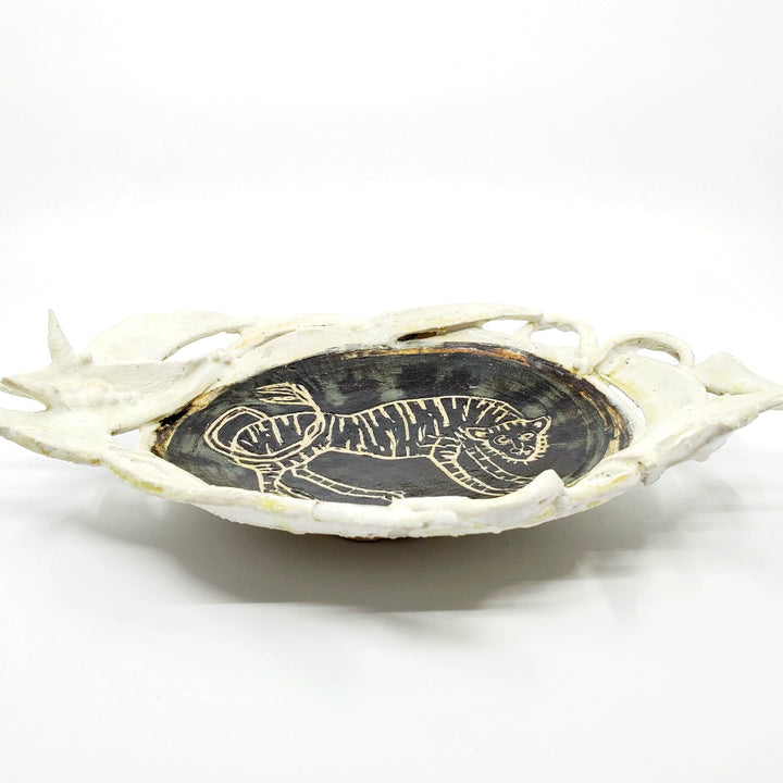 Medium-large oval platter with a tiger carved into the glaze.