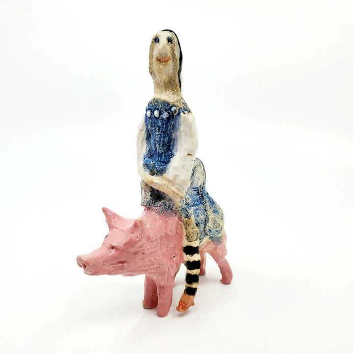 Witch on pig: small ceramic figure.