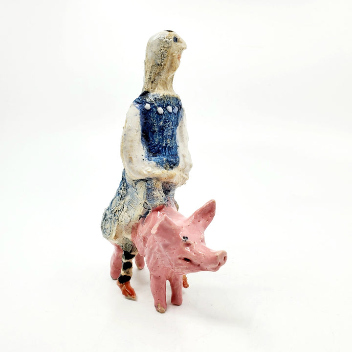 Witch on pig: small ceramic figure.