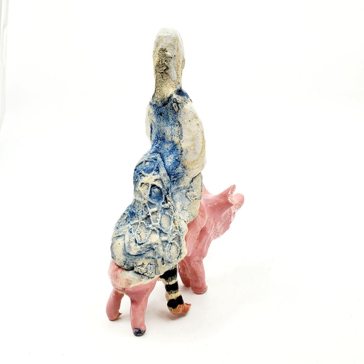 Witch on pig: small ceramic figure.