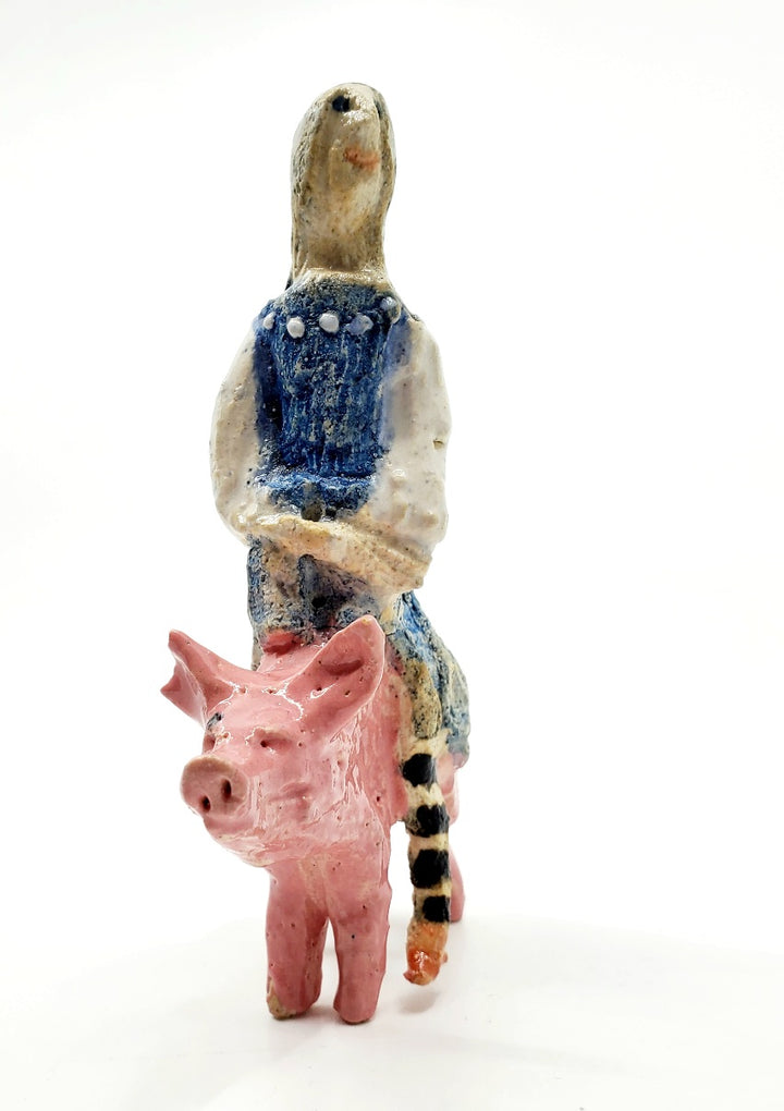 Witch on pig: small ceramic figure.