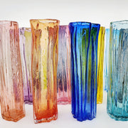 Xylem narrow vases are available in a variety of rich and vibrant colours. These hand blown glass vessels will liven up home or office and make wonderful sets.