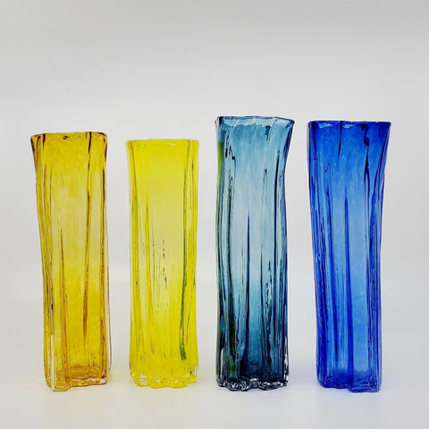 Xylem narrow vases are available in a variety of rich and vibrant colours. These hand blown glass vessels will liven up home or office and make wonderful sets. - Golden topaz, Yellow, Dark teal, Cobalt