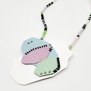 Pastel Geo Sewn Necklaces combine repurposed powder-coated copper and fibre art. The metal segments are stitched together with embroidery thread, which also winds around the cotton cord.