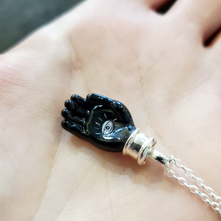 Helping hand: small murrine glass and hot-worked glass pendant on a 20" sterling silver chain.