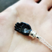 Helping hand: small murrine glass and hot-worked glass pendant on a 20" sterling silver chain.