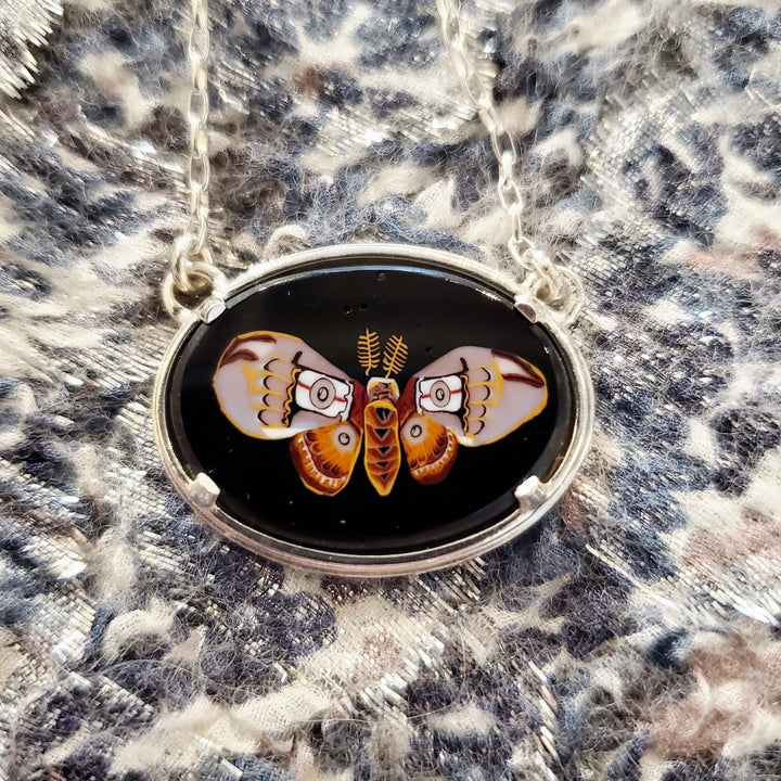Emperor moth murrine glass pendant on a 20" sterling silver chain.