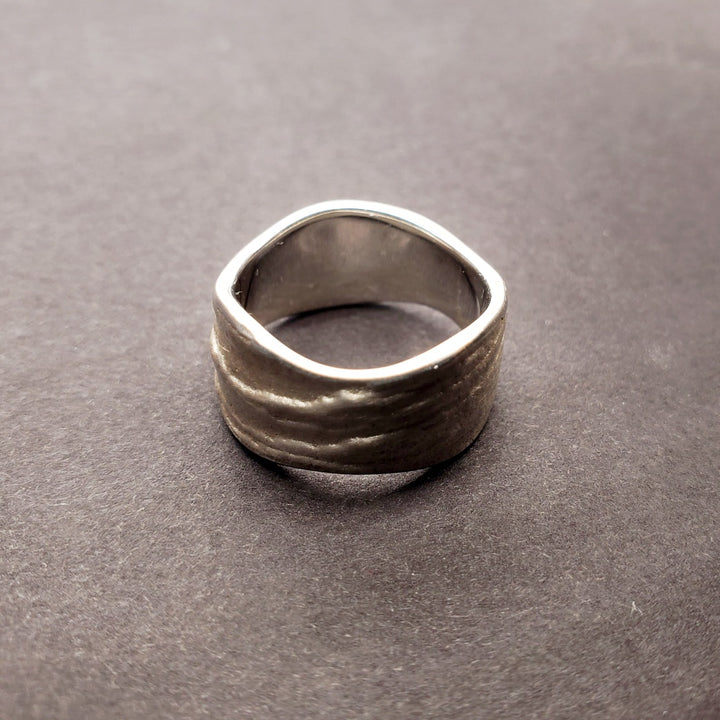 Origins wide band sterling silver ring. The texture is an impression of slate. Size 7.5