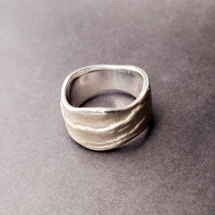 Origins wide band sterling silver ring. The texture is an impression of slate. Size 7.5