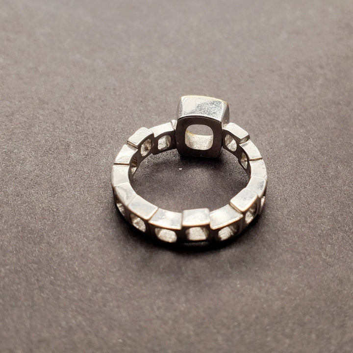 Diamond Geometrica Ring with the 11 diamonds rounding half the 18k gold face, atop a band of staggered sterling silver cubes, with eleven 1 mm diamonds, size 6.