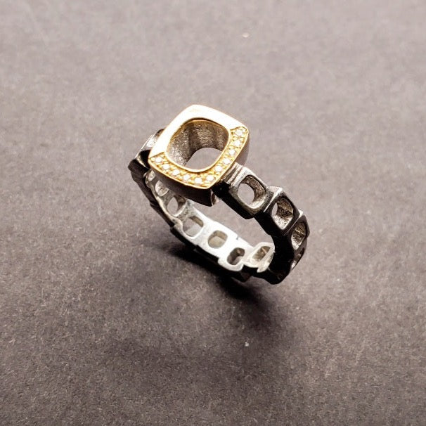 Diamond Geometrica Ring with the 11 diamonds rounding half the 18k gold face, atop a band of staggered sterling silver cubes, with eleven 1 mm diamonds, size 6.