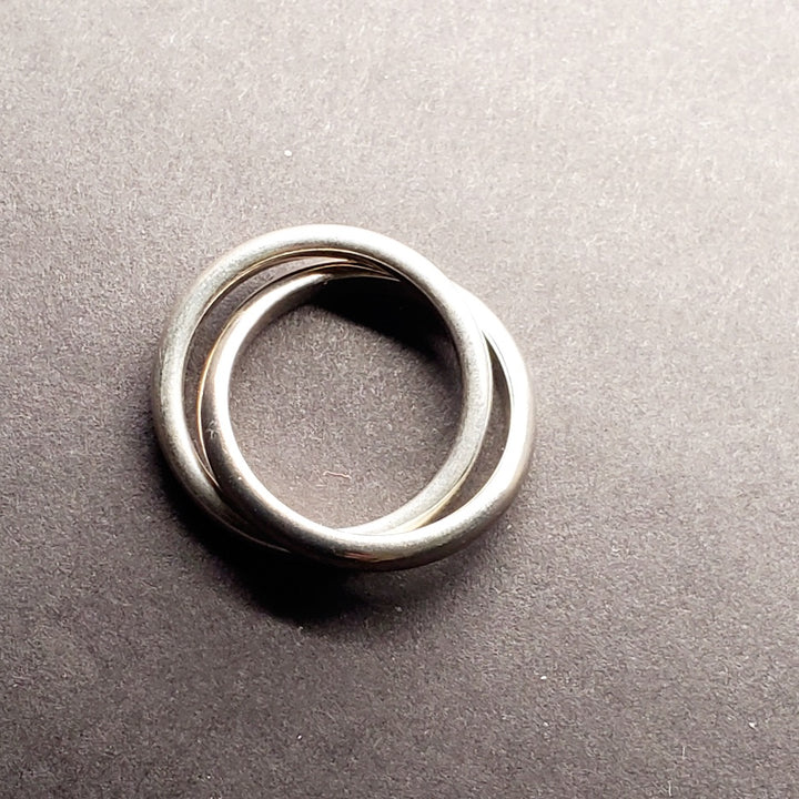 Interlocking rings of sterling silver and titanium, size 6.5.