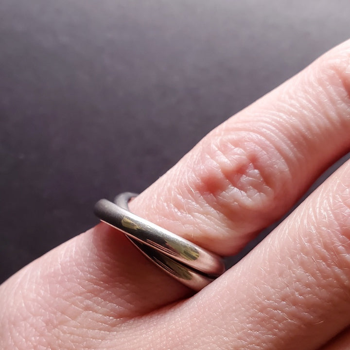 Interlocking rings of sterling silver and titanium, size 6.5.
