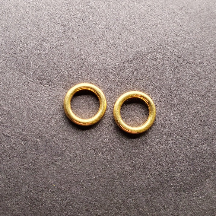 Tiny 14k gold circle stud earrings.