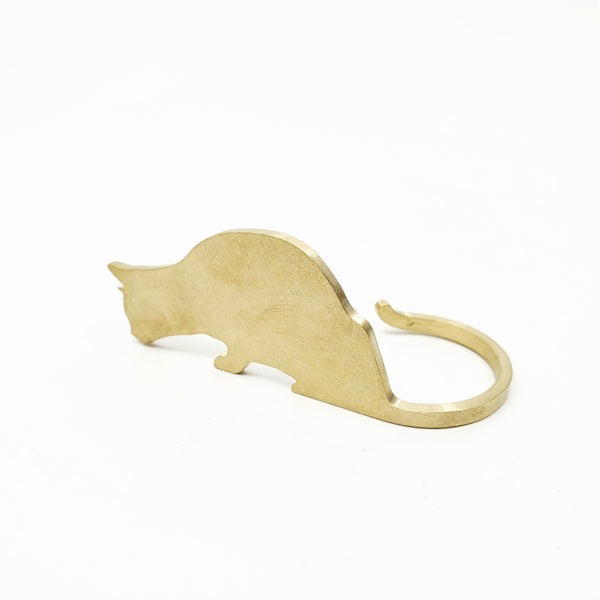 Brass cat eating. Charming brass table object which can be posed facing to the left or to the right. Sold individually.