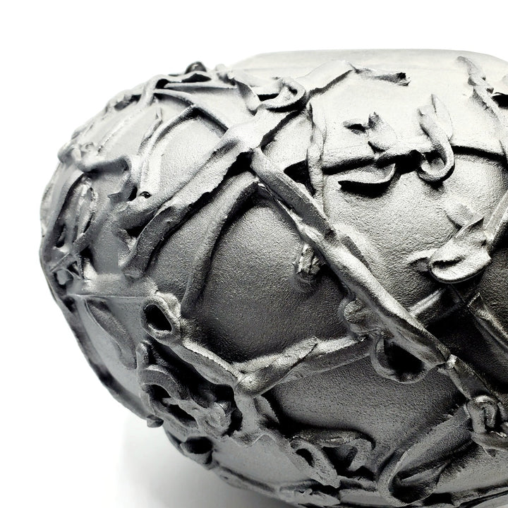 Large black vase. Ribbons of clay applied to its surface create a strong texture.