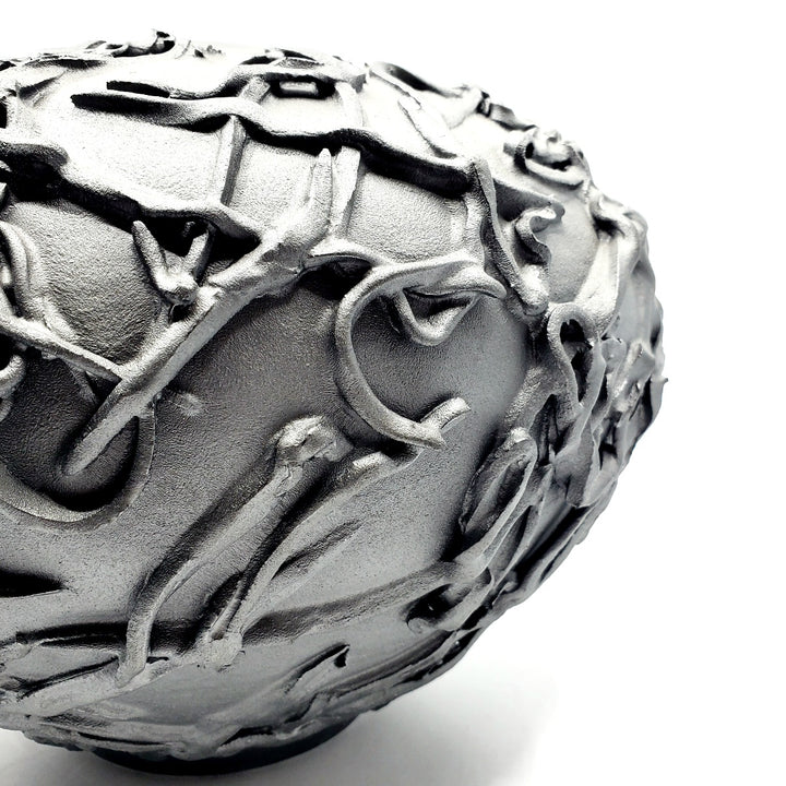 Large black vase. Ribbons of clay applied to its surface create a strong texture.