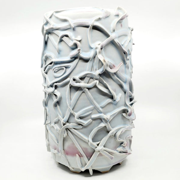 Pale blue-grey vase. Ribbons of clay applied to its surface create a strong texture. The interior is dappled with brown and purple.