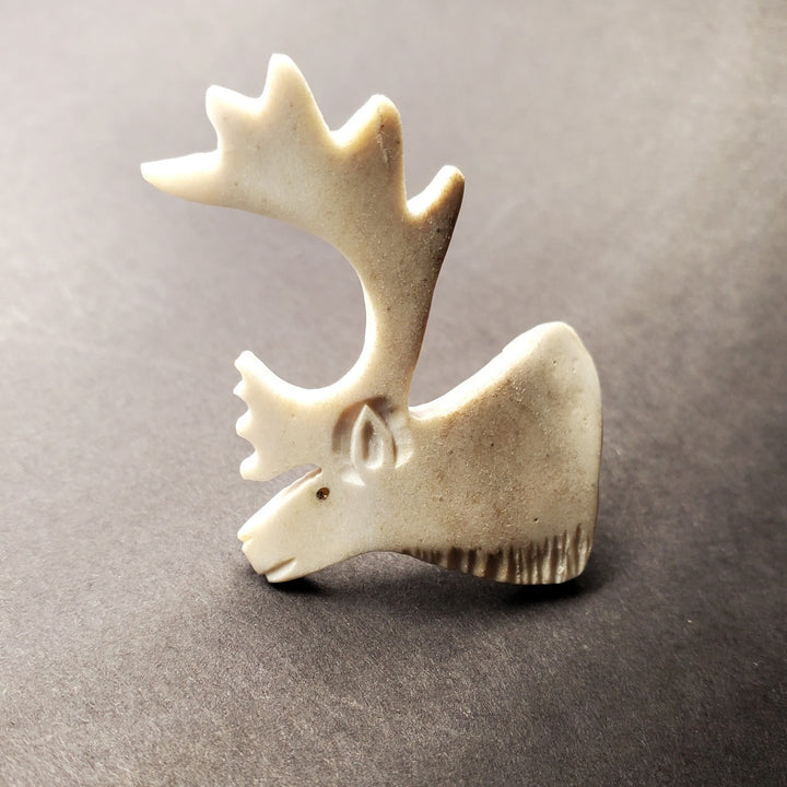 Caribou head brooch in caribou antler.