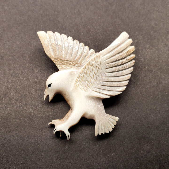 Falcon pin in caribou antler.