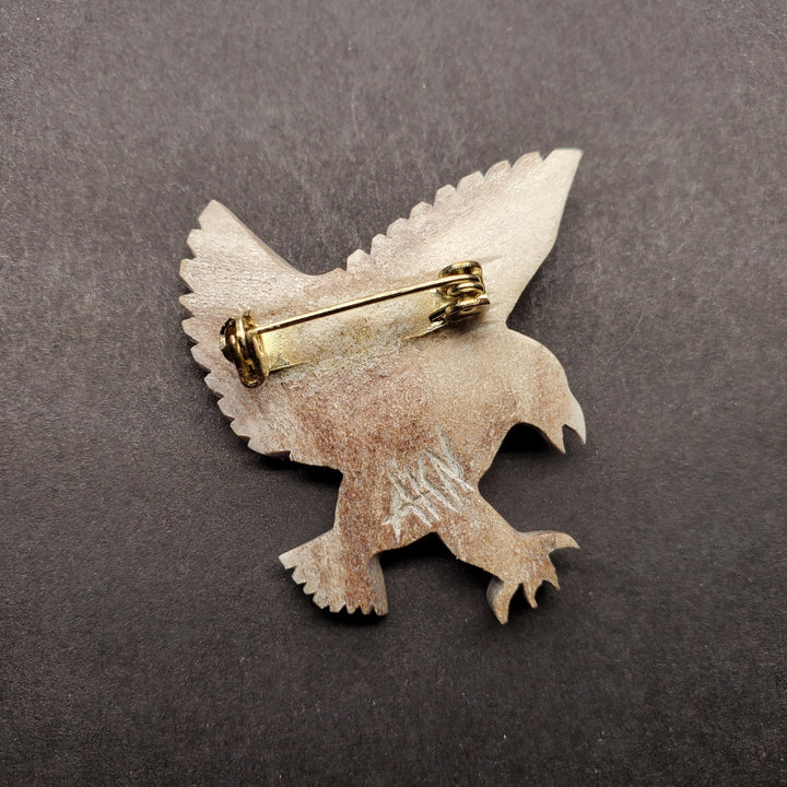 Falcon pin in caribou antler.
