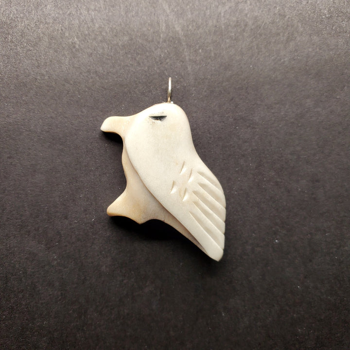 Bird pendant made from caribou antler.