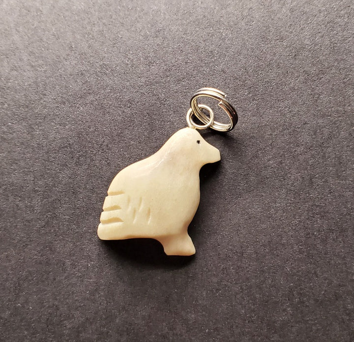 Small snow bunting pendant made from caribou antler.