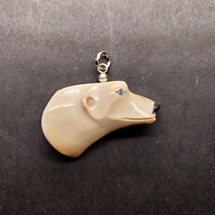 Polar bear head pendant in caribou antler.