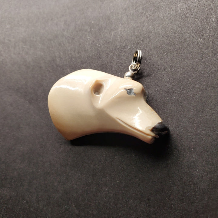 Polar bear head pendant in caribou antler.