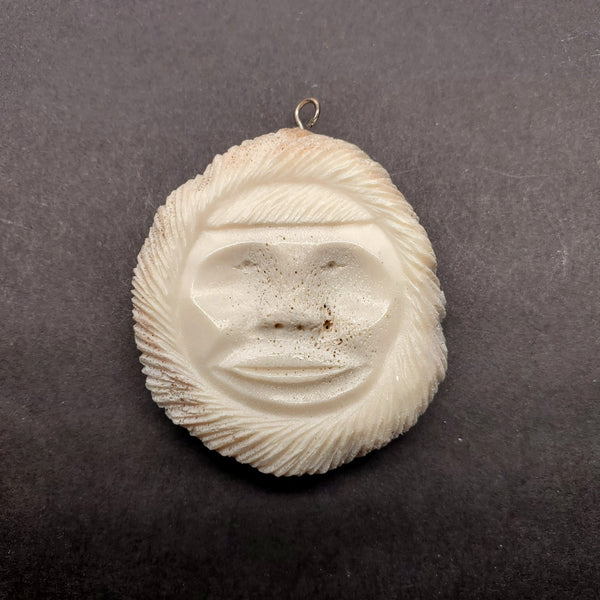 Inuk face pendant of caribou antler.