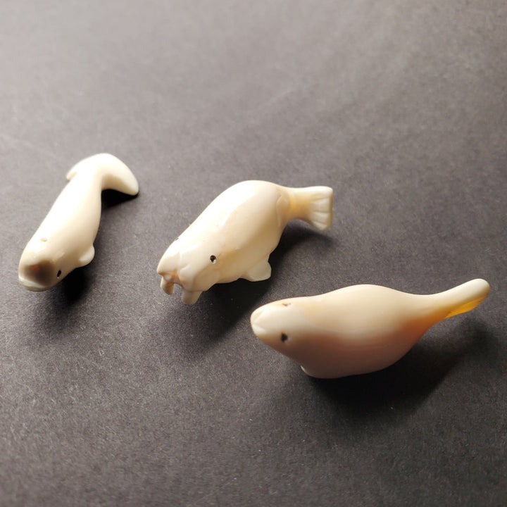 Mini beluga whale carving. Pictured here with his mini walrus and mini seal carvings.