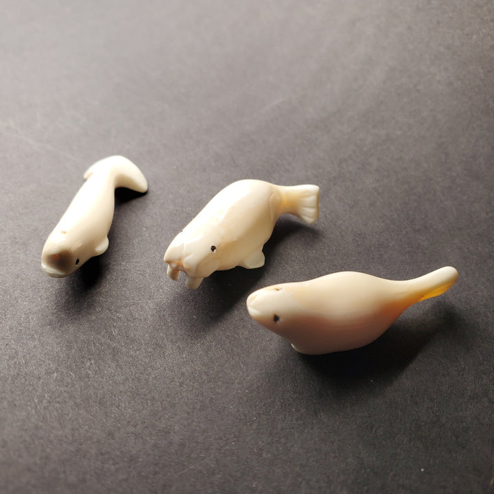 Mini seal carving. Pictured here with his mini beluga and mini walrus carvings.
