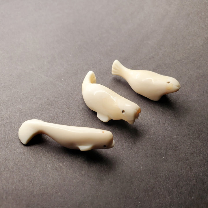 Mini beluga whale carving. Pictured here with his mini walrus and mini seal carvings.