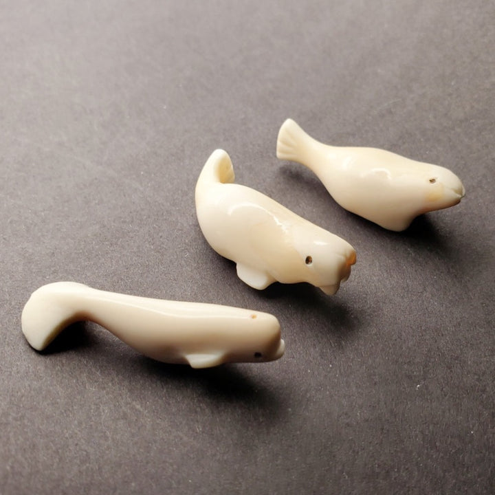 Mini seal carving. Pictured here with his mini beluga and mini walrus carvings.