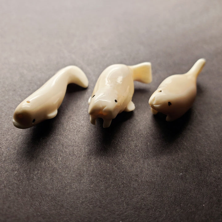 Mini beluga whale carving. Pictured here with his mini walrus and mini seal carvings.