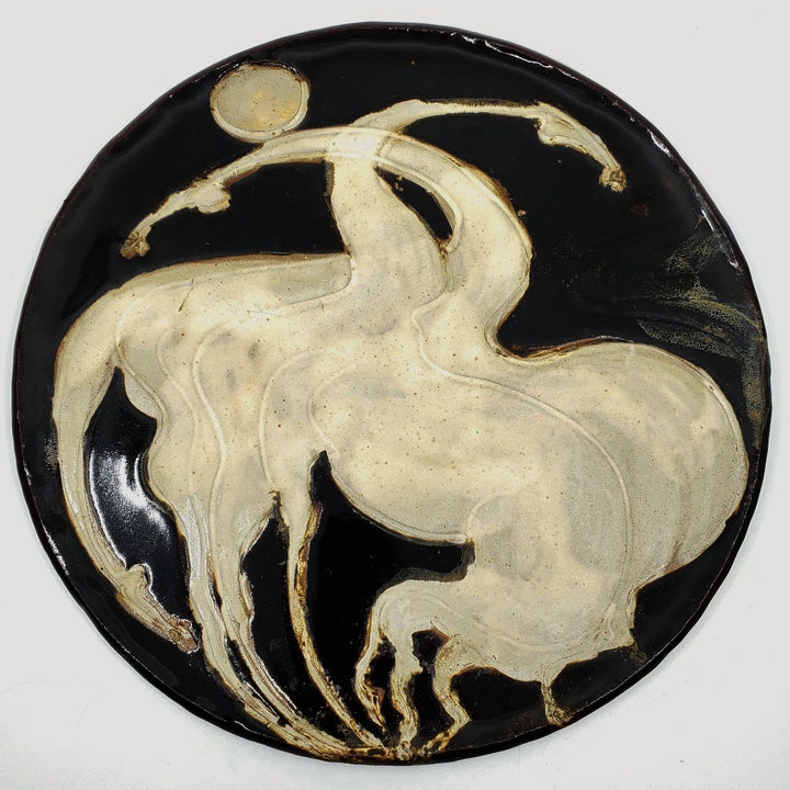 Ceramic plate depicting two horses. 12" in diameter.