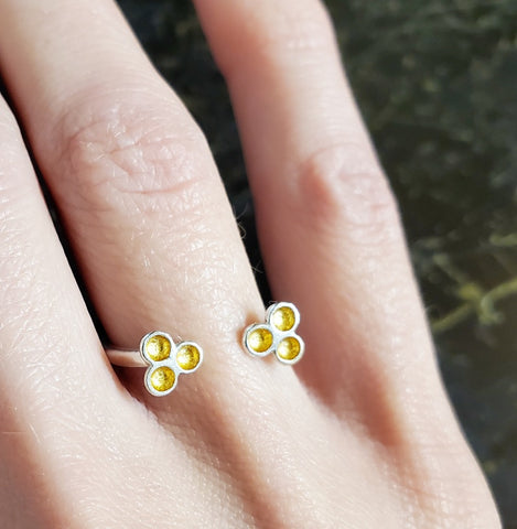 Petite Bloom ring. Each end of this delicate sterling band blossoms into a tiny flower with 22k gold leaf and resin. Fits approximately size 6, but the open band allows for some wiggle room.