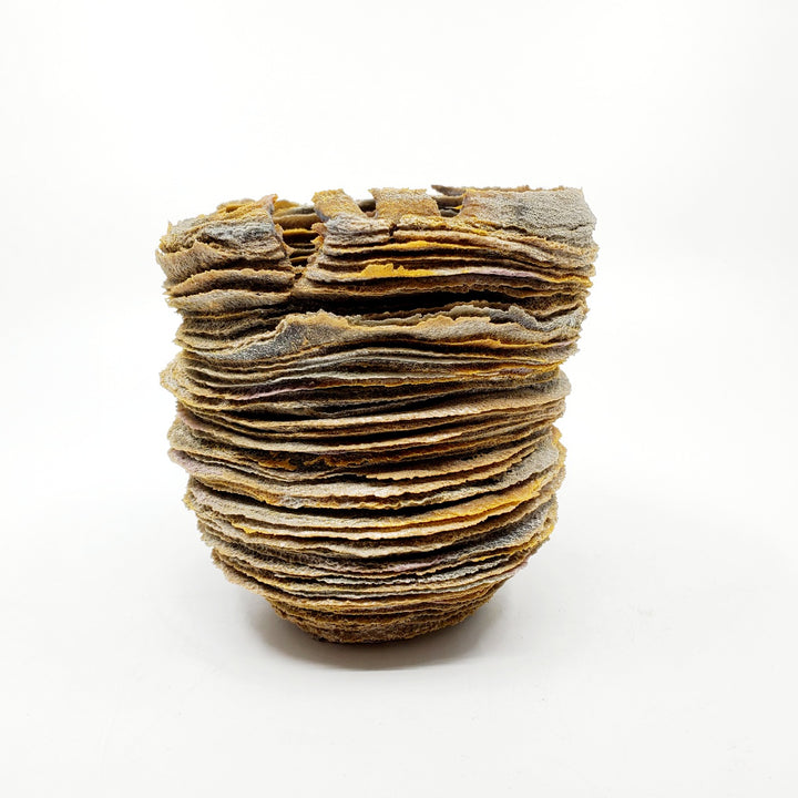Cherished: Contemplation, glass vessel, 2022. The artist manipulates the physical characteristics of powdered glass, building it up in layers to achieve organic forms reminiscent of land formations.  5" x 5" x 5"