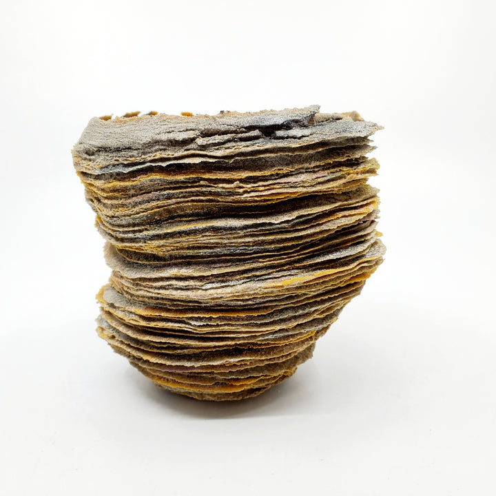 Cherished: Contemplation, glass vessel, 2022. The artist manipulates the physical characteristics of powdered glass, building it up in layers to achieve organic forms reminiscent of land formations.  5" x 5" x 5"