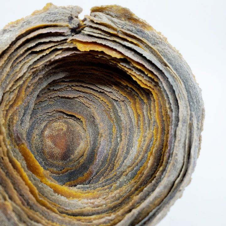 Cherished: Contemplation, glass vessel, 2022. The artist manipulates the physical characteristics of powdered glass, building it up in layers to achieve organic forms reminiscent of land formations.  5" x 5" x 5"