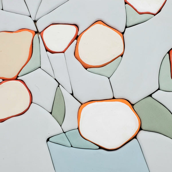 All Things - Hand molded clay coloured pieces within a solid wood frame, depicting a still life of white and orange flowers.  Measures 25 x 25 x 2.5 cm