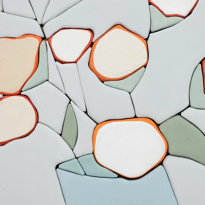 All Things - Hand molded clay coloured pieces within a solid wood frame, depicting a still life of white and orange flowers.  Measures 25 x 25 x 2.5 cm
