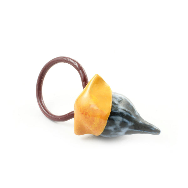This colourful ring pendant comes a collaborative series completed by artists Catherine Granche and Karine Rodrigue. Created as an exploratory project, this piece reflects a multi purpose piece of jewellery as they can be worn as a pendant as well as a ring based upon the wearers preference. The pendant ring is made from porcelain, copper, paraloid and enamel paint, strung by cotton or synthetic thread. 