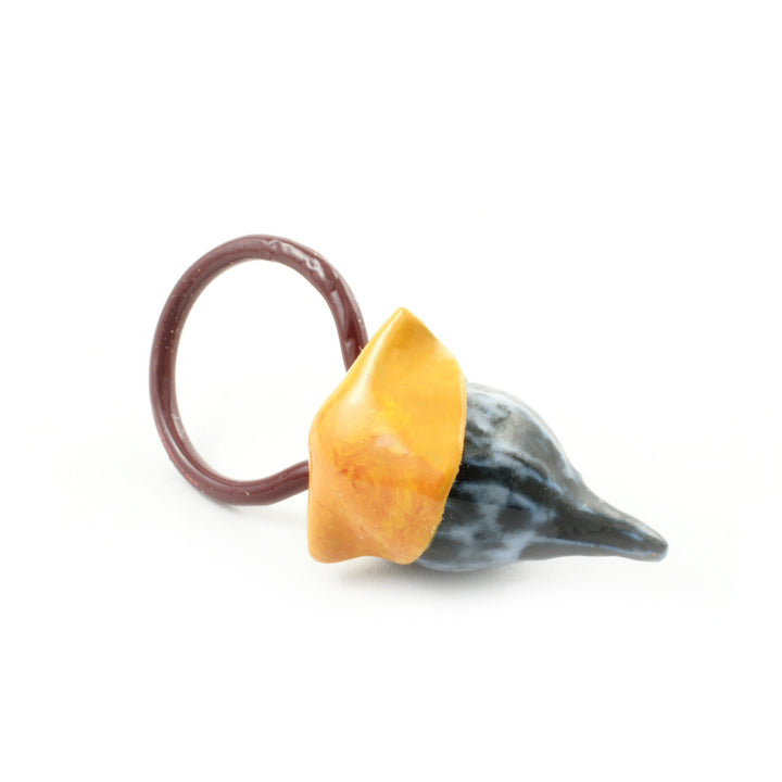 This colourful ring pendant comes a collaborative series completed by artists Catherine Granche and Karine Rodrigue. Created as an exploratory project, this piece reflects a multi purpose piece of jewellery as they can be worn as a pendant as well as a ring based upon the wearers preference. The pendant ring is made from porcelain, copper, paraloid and enamel paint, strung by cotton or synthetic thread. 
