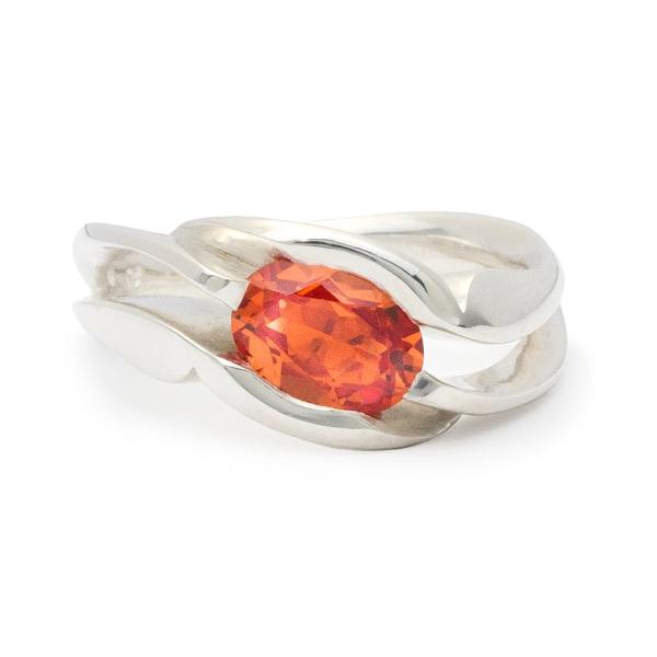 Unison, ring in sterling silver with lab-created padparadscha sapphire.(8 x 6mm).  Ring size: 6.5  This ring features an asymmetrical design and can be worn on either hand. The square shank helps the ring remain upright and adds strength and longevity.