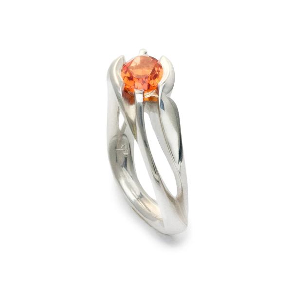 Unison, ring in sterling silver with lab-created padparadscha sapphire.(8 x 6mm).  Ring size: 6.5  This ring features an asymmetrical design and can be worn on either hand. The square shank helps the ring remain upright and adds strength and longevity.