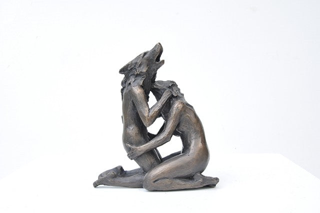 Anna Williams She Wolves in double. Two She Wolves sitting face-to-face, holding one another. Individual cast bronze sculpture, approx. 7" x 4" x 3".